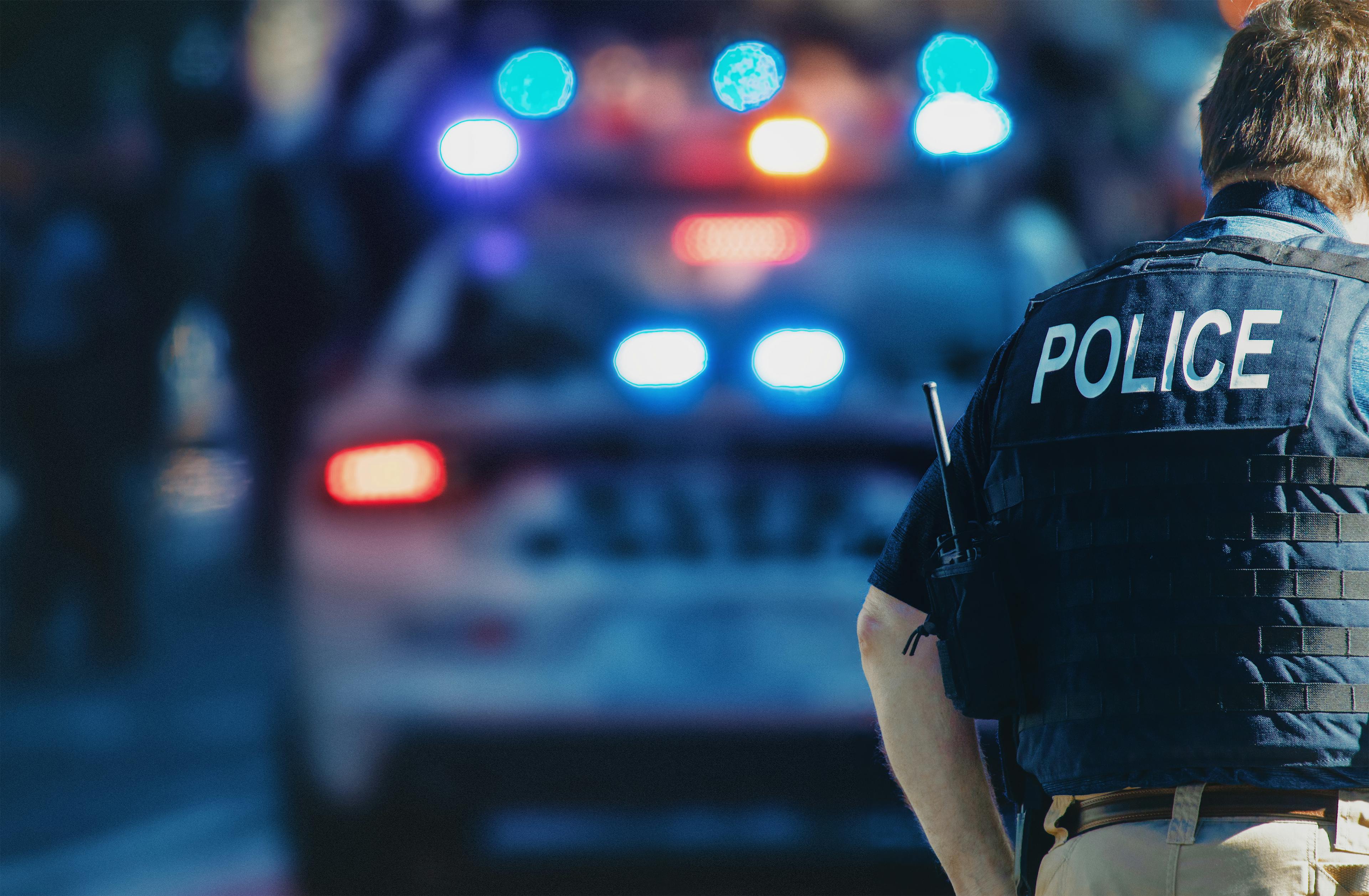 police officer in front of car